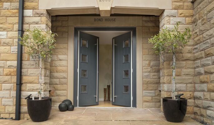 Home entrance featuring a bold grey composite door with glass inserts